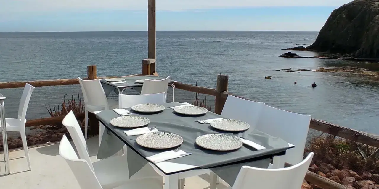 Mesas puestas con vistas al mar, ideal para saber donde comer en Almería.