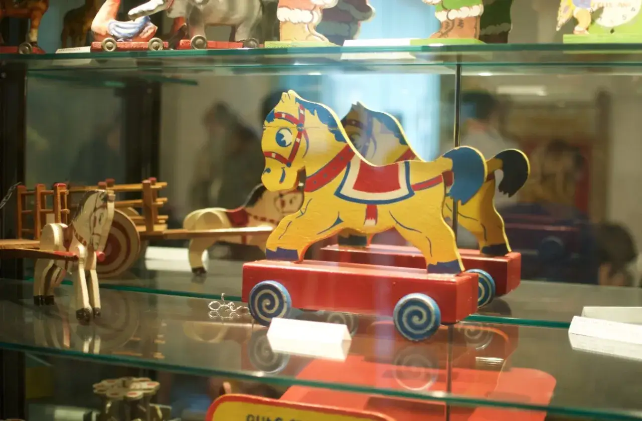 Caballitos de madera amarillos y rojos, parte de una exhibición en el museu de la joguina sant feliu de guixols.
